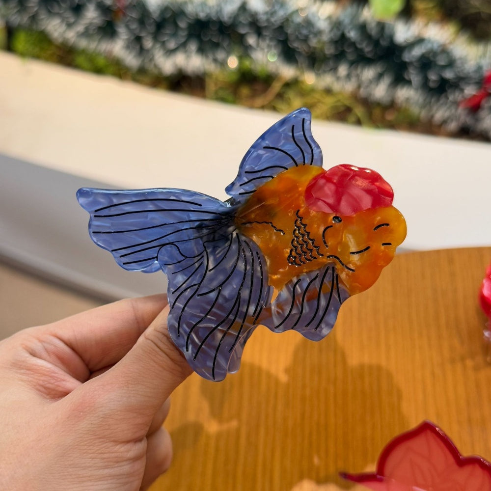 Blue-tailed goldfish claw clamp hair clip by Alorar featuring a vibrant ocean-themed design.