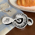 Alorar musical symbols hair claw clamp featuring a decorative design of notes and clefs on a sturdy clip.