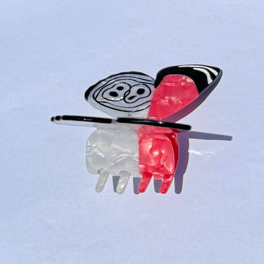 Red ring skirt hair claw clamp by Alorar featuring a butterfly design, ideal for securing hair in style.