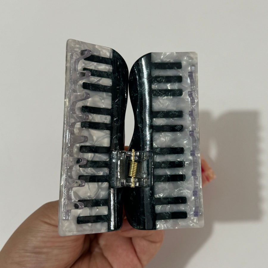 Alorar classic piano hair claw clamp in a stylish design, perfect for securing hair in a chic updo or ponytail.