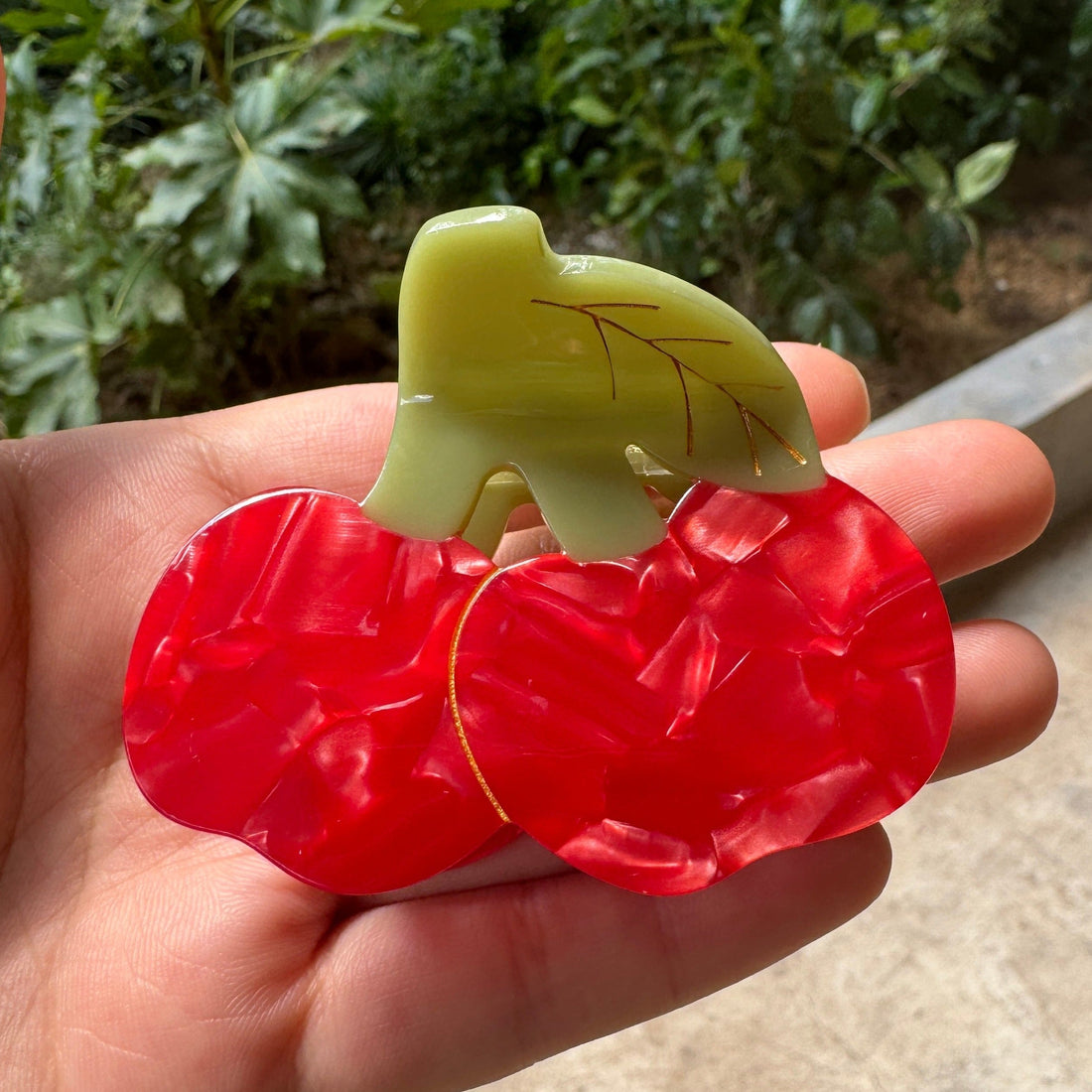 Alorar cherry bomb hair claw clamp with vibrant red color and decorative design, ideal for stylish hair updos.